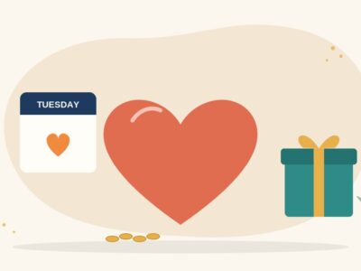 Illustration of a large red heart between a calendar page marked Tuesday and a wrapped gift box, with a few coins, for GivingTuesday in India