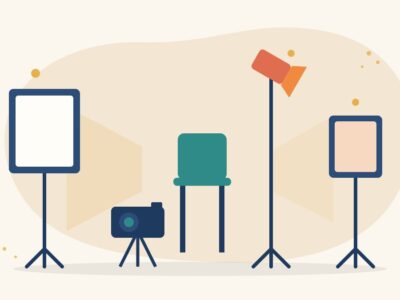 Illustration of a three-point lighting setup with a key light softbox, a fill light and a back light aimed at an empty chair in front of a camera on a tripod